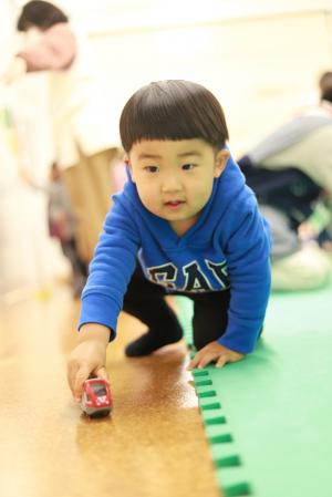車を走らせて遊ぶ子供